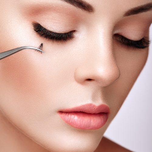 Beautiful woman with long false eyelashes